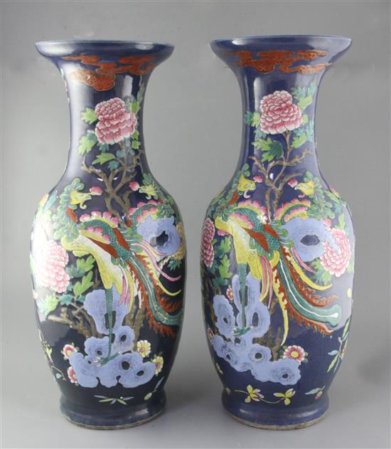 A pair of large Chinese blue ground dragon and phoenix vases, 19th century, restorations
